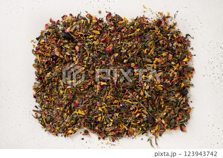Pile of dry herbal tea and flowers green tea on white background. View from above. Dry tea leaves texture. 123943742