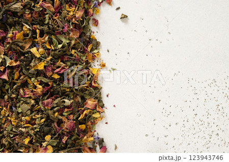 Dry herbal tea and green tea as frame on white background. View from above. Copy space. Dry tea leaves texture. Dry herbal tea and green tea as frame on white background. View from above. Copy space. Dry tea leaves texture. 123943746