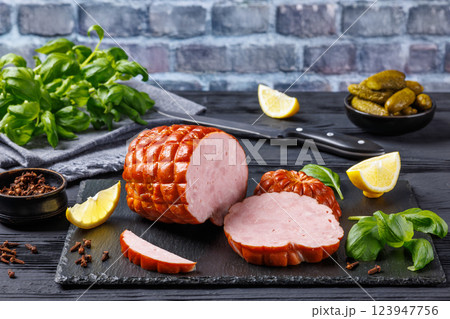 boneless smoked ham on black slate board, top view boneless smoked ham on black slate board, top view 123947756