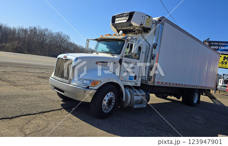 Freight liner Semi-Truck Driving on Open Highway in a Rural Area, CDL Truck  showcasing commercial transportation, logistics efficiency, and professional trucking 123947901