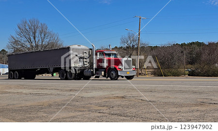 Freight liner Semi-Truck Driving on Open Highway in a Rural Area, CDL Truck showcasing commercial transportation, logistics efficiency, and professional trucking Freight liner Semi-Truck Driving on Open Highway in a Rural Area, CDL Truck showcasing commercial transportation, logistics efficiency, and professional trucking 123947902