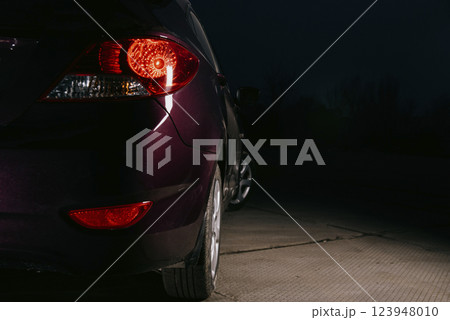 Rear of a dark burgundy car. Rear of a dark burgundy car. 123948010