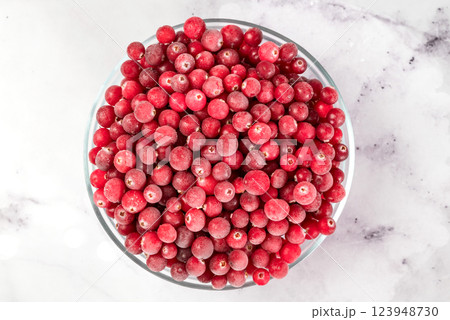 bowl of frozen cranberries on light background. Preservation of vegetables and fruits. Natural products 123948730