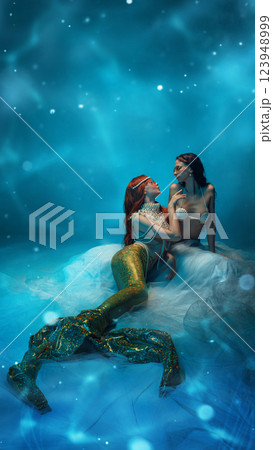 Mystical ocean goddess adorned in pearls, wearing sunglasses, exuding elegance and mystery in a glowing underwater world. 123948999