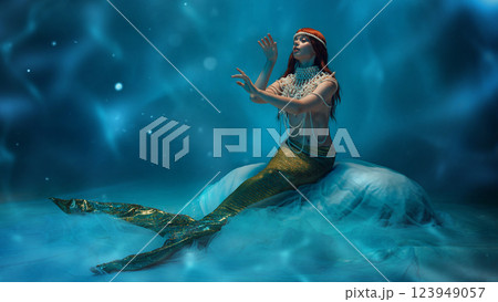 Fantasy touch. Beautiful young woman, graceful mermaid sitting in tender pose deep in the ocean with wavy pattern and soft lights. Fantasy touch. Beautiful young woman, graceful mermaid sitting in tender pose deep in the ocean with wavy pattern and soft lights. 123949057