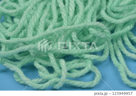 Tangled pile of light green yarn Tangled pile of light green yarn 123949957