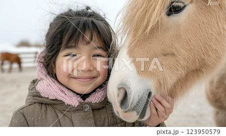 Young asian girl smiling with pony in snowy farm setting 123950579