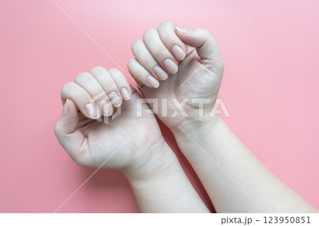 Female hands with short natural nails 123950851