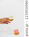 Two shortbread cakes with cream. One cake in a woman's hand. White background. 123950990