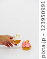 Two shortbread cakes with cream. One cake in a woman's hand. White background. 123950991