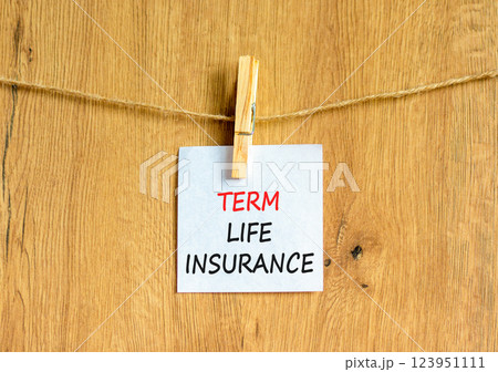 Term life insurance symbol. Concept words Term life insurance on beautiful white paper on clothespin. Beautiful wooden background. Business term life insurance concept. Copy space. 123951111