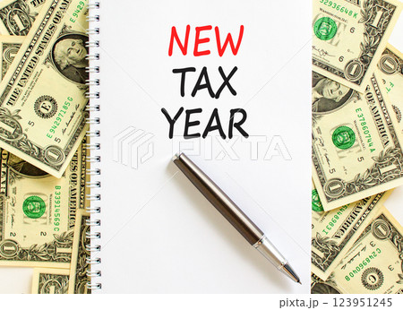 New tax year symbol. Concept words New tax year on beautiful white note. Beautiful background from dollar bills. Black pen. Business new tax year concept. Copy space. 123951245