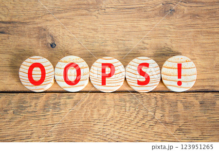 Oops symbol. Concept word Oops on beautiful wooden circles. Beautiful wooden table wooden background. Business lifestyle oops concept. Copy space. 123951265