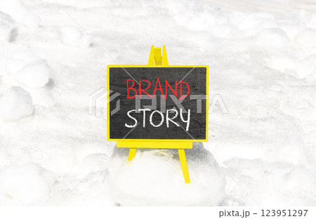Brand story branding symbol. Concept words Brand story on beautiful yellow chalk blackboard. Beautiful white snow background. Business brand story branding concept. Copy space. Brand story branding symbol. Concept words Brand story on beautiful yellow chalk blackboard. Beautiful white snow background. Business brand story branding concept. Copy space. 123951297