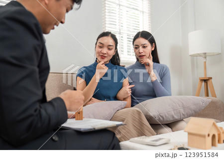 Real estate agent explaining property details to interested clients 123951584