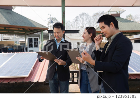 Green technology discussion. Team exploring innovative energy-efficient ideas outdoors. 123951585