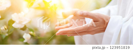 Hand of Jesus reaching out with light in spiritual scene, religious concept background Hand of Jesus reaching out with light in spiritual scene, religious concept background 123951819
