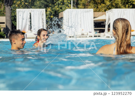 Funny teenagers in swimsuits and sunglasses in the pool. Joyful children are having fun in the water Funny teenagers in swimsuits and sunglasses in the pool. Joyful children are having fun in the water 123952270
