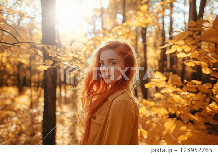 Young woman walking in bright autumn forest 123952765