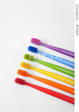 Six colorful toothbrushes on a white background. Rainbow. Place for text. Ritual. Oral hygiene. Children's. 123954121