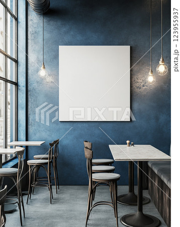 Wall art mockup in a modern cafe with a blank canvas on the wall. The cafe has blue and grey hues.  123955937