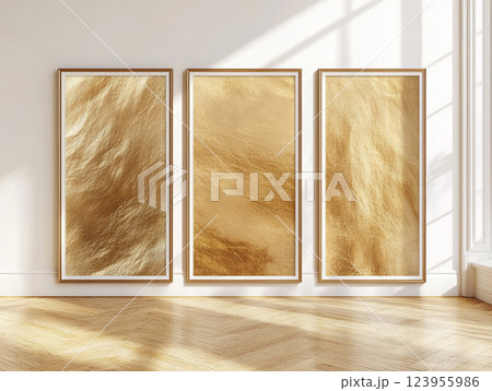 Empty frames hang on a wall above a decorative wooden floor, casting shadows. 123955986