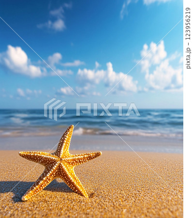 A vibrant yellow starfish with white spots rests on a sandy beach under a bright blue sky with scattered clouds and sunlight. A vibrant yellow starfish with white spots rests on a sandy beach under a bright blue sky with scattered clouds and sunlight. 123956219
