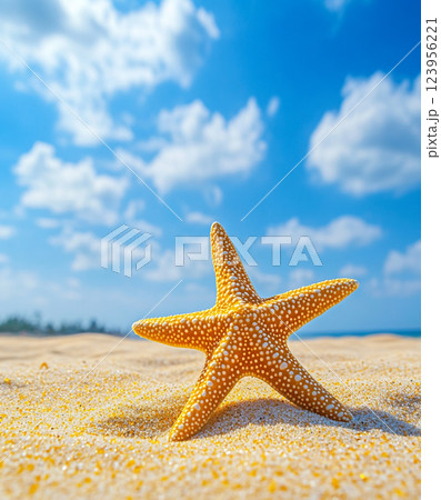 A vibrant yellow starfish with white spots rests on a sandy beach under a bright blue sky with scattered clouds and sunlight. A vibrant yellow starfish with white spots rests on a sandy beach under a bright blue sky with scattered clouds and sunlight. 123956221