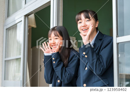 教室の窓から声援を送る女子中学生・女子高生 123958402