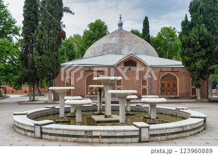 Juma Mosque in Ganja, Azerbaijan, showcasing distinctive red brick facade and prominent water fountain in the foreground Juma Mosque in Ganja, Azerbaijan, showcasing distinctive red brick facade and prominent water fountain in the foreground 123960889