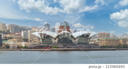 View of the Deniz Mall in Baku, Azerbaijan, showcasing its modern architectural design against blue sky View of the Deniz Mall in Baku, Azerbaijan, showcasing its modern architectural design against blue sky 123960893