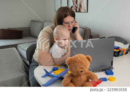 A busy parent balancing work demands with effective childcare management at home A busy parent balancing work demands with effective childcare management at home 123961038