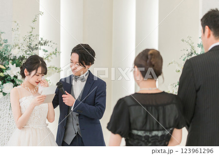 結婚式で両親への手紙を読む新婦・花嫁(両親・父親・花嫁の手紙・泣く) 結婚式で両親への手紙を読む新婦・花嫁(両親・父親・花嫁の手紙・泣く) 123961296
