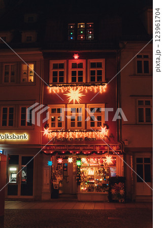 illuminated european building facade during christmas season with glowing lights and holiday charm. High quality photo 123961704