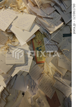 Close-up of handwritten notes and wishes pinned to a display, symbolizing personal messages during a cultural or festive event. High quality photo Close-up of handwritten notes and wishes pinned to a display, symbolizing personal messages during a cultural or festive event. High quality photo 123961780