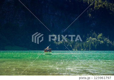 Konigssee Lake in Bavaria Germany with Church by the Lake White Boat Forested Mountain and Beautiful Sunny Trekking in Berchtesgaden German Alps. High quality photo Konigssee Lake in Bavaria Germany with Church by the Lake White Boat Forested Mountain and Beautiful Sunny Trekking in Berchtesgaden German Alps. High quality photo 123961797