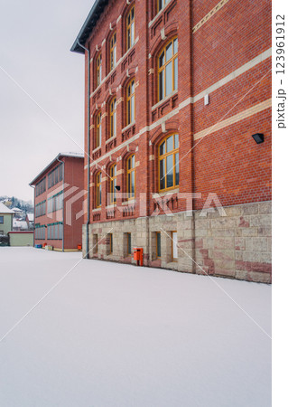 A picturesque snowy road gracefully winding through a charming little village during the magical winter season A picturesque snowy road gracefully winding through a charming little village during the magical winter season 123961912