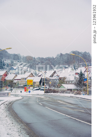 A picturesque snowy road gracefully winding through a charming little village during the magical winter season 123961932