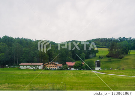 Scenic countryside view featuring traditional buildings surrounded by lush greenery in a tranquil rural setting Konigssee Bavaria German Apls. High quality photo 123961967