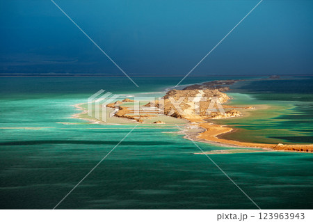 Seascape in the morning at dramatic light. Small island in the Dead Sea. View of Jordan from Israel Seascape in the morning at dramatic light. Small island in the Dead Sea. View of Jordan from Israel 123963943