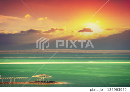 Seascape in the morning. Orange sunrise over the Dead Sea. View of Jordan from Israel Seascape in the morning. Orange sunrise over the Dead Sea. View of Jordan from Israel 123963952