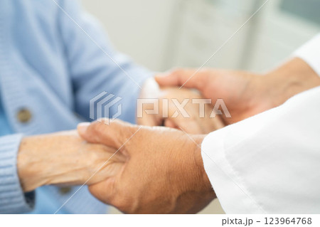 Doctor holding hands Asian elderly woman patient, help and care in hospital. Doctor holding hands Asian elderly woman patient, help and care in hospital. 123964768