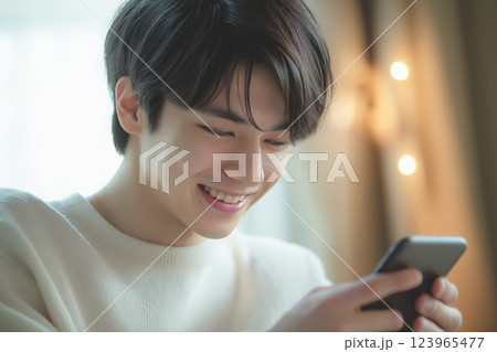 スマホを操作する若いアジア人男性「AI生成画像」 123965477