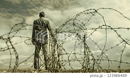 Debt Concept, Man caught in a barbed wire fence of economic downturn 123966489