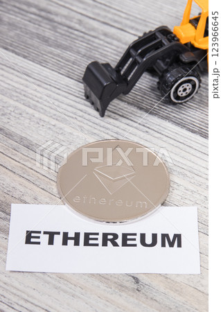 Ethereum and miniature excavator. Cryptocurrency. International network payment. Finance concept 123966645