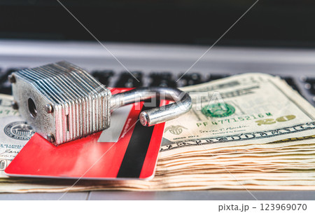 Concept of online payment with card, security and finance. Open padlock with credit card and dollar bills 123969070