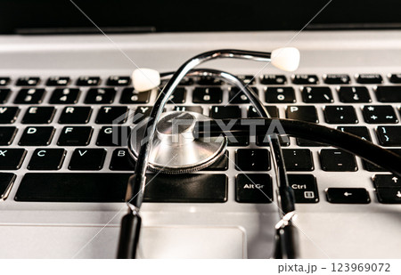 Online medical consultation concept. Stethoscope on laptop keyboard 123969072