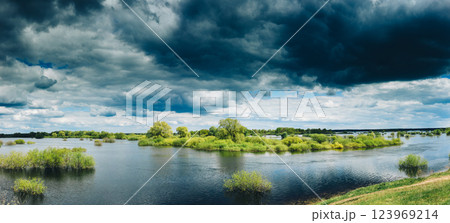 Countryside Landscape During Spring Flood Floodwaters. Bold Bright Blue Sky Above Nature Landscape During Spring Flood. Amazing Reflections In River. Musical Calmness Concept. Tranquil View Countryside Landscape During Spring Flood Floodwaters. Bold Bright Blue Sky Above Nature Landscape During Spring Flood. Amazing Reflections In River. Musical Calmness Concept. Tranquil View 123969214