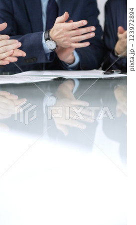 Business people applauding and celebrating achievements at glass table after successful meeting in office, vertical close up view. Concept of success Business people applauding and celebrating achievements at glass table after successful meeting in office, vertical close up view. Concept of success 123972894