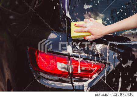 Car washing with a sponge.  123973430